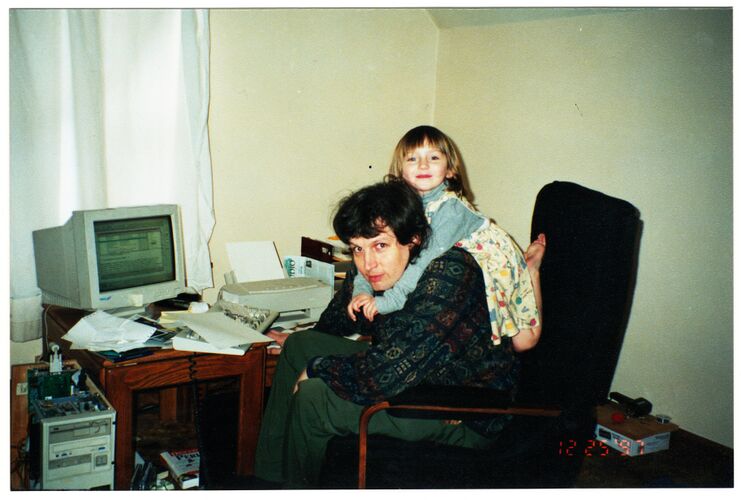 1997-12-25.005.Anna on W back in black chair in Appleton apartment.adj.jpg